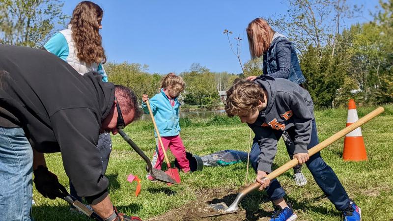 The Koller family prepares a spot for their Eastern Cottonwood. Shown are (l-r) Patrick, Adrianna, Sophia, Tiffany and Logan.