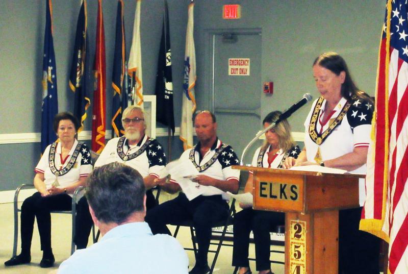 Opening the Cape Henlopen Elks 2540 Flag Day ceremony is Exalted Ruler Joanne Mayer at the podium. Seated are officers (l-r) Lynn Clougher, past exalted ruler and trustee; Paul Holton, past exalted ruler and trustee; Marty Schreck, esteemed lecturing knight; and Joy Schreck, esteemed leading knight. SUBMITTED PHOTOS