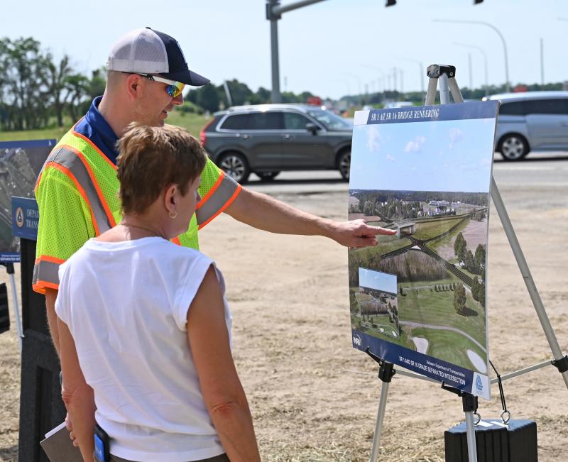 Delaware Department of Transportation Community Relations Director Charles “C.R.” McLeod discusses the project with Karen McGrath, Sussex County director for Sen. Tom Carper’s office.