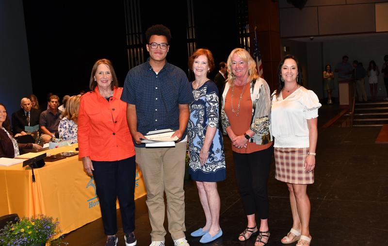 Brayden Rochester received an award from Cape Henlopen Taxpayers for Fair Elections, a scholarship from the Col. David Hall Chapter of the Daughters of the American Revolution, the J.D. O'Connor Scholarship Fund, O.W.L. Fund President's Award for Educational Excellence, an award from the State of Delaware Daughters of the American Revolution, the State of Delaware Secretary of Education Scholar Award and the Thurman Adams & Hilda McCabe Adams Family Scholarship. Shown are (l-r) Debbie Russo, Rochester, Frances O’Reilly, Janet Lawson and Principal Nikki Miller.
