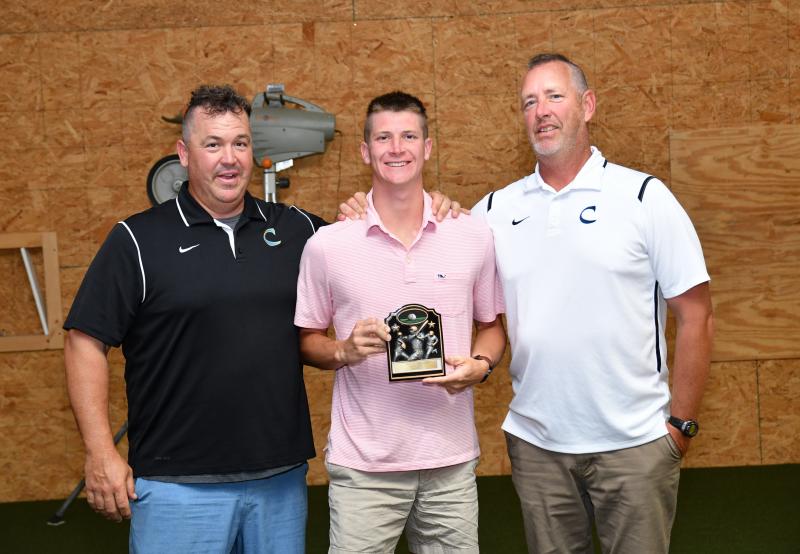Senior Austin Rhue receives the Defensive MVP Award from head coach Ben Evick, left, and assistant Drew Johnson.