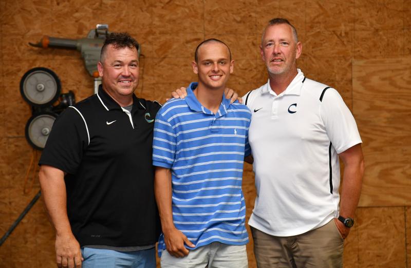 Junior Timmy Hitchcock receives the Chris Short Award from from head coach Ben Evick, left, and assistant Drew Johnson.