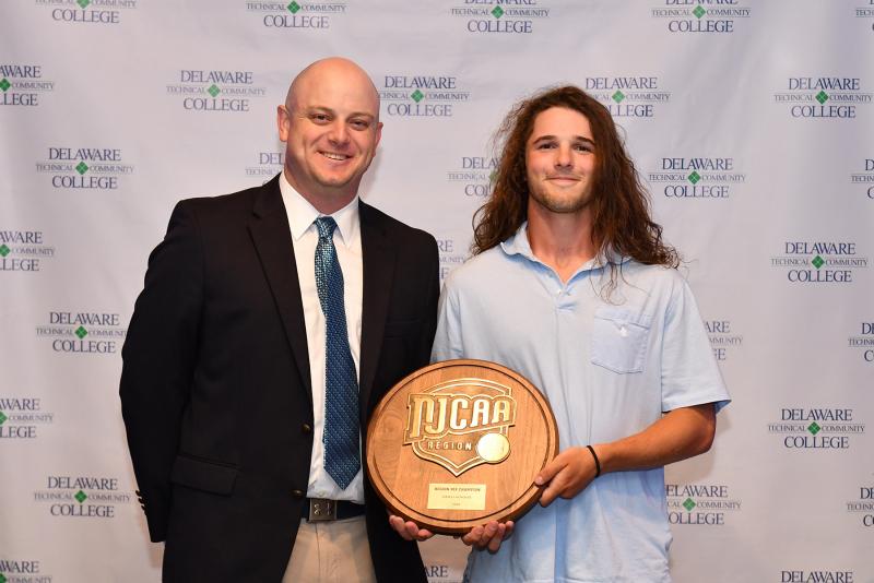 Franc Cook, Del Tech assistant coach and student-athlete support specialist, and face-off specialist Louis Savino display the Region 19 Championship plaque. Savino was presented the team Sportsmanship Award.