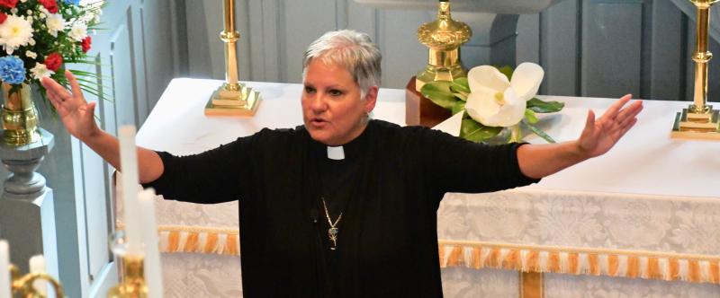 The Rev. Shelley McDade, pastor at St. George’s Chapel, offers a blessing of peace to those attending a Memorial Day service in the historic chapel.