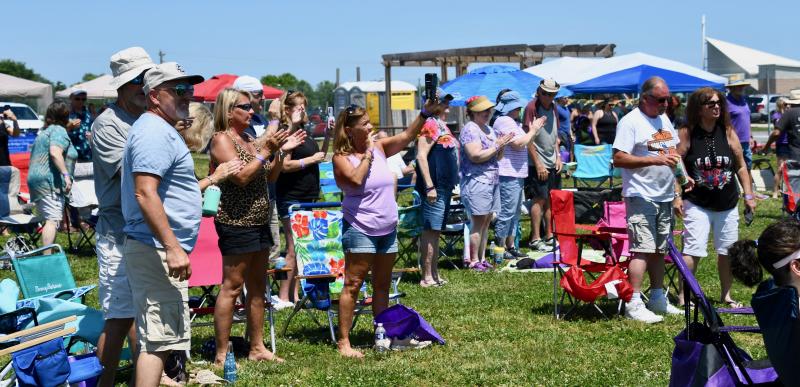 A large crowd gets to its feet during the first song played by Company B, a Bad Company tribute band.