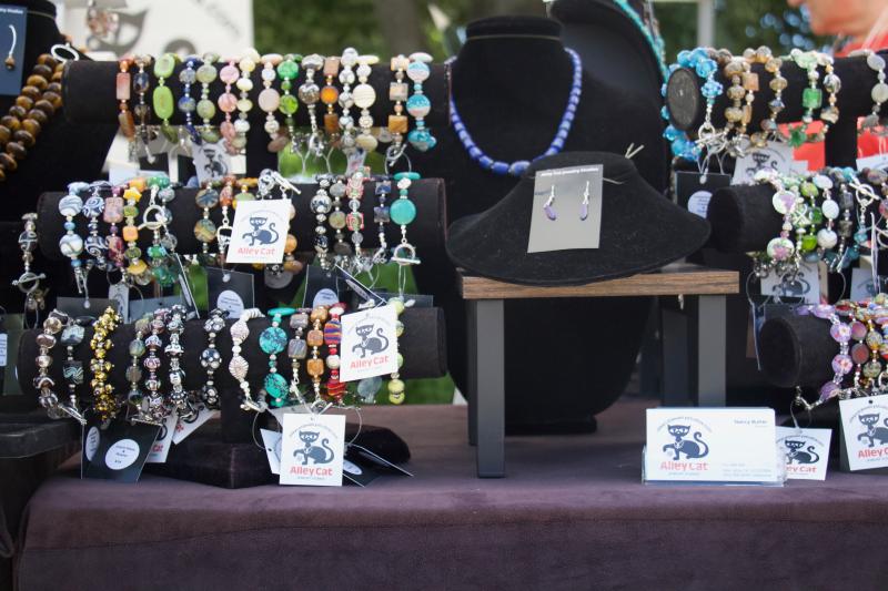 Alley Cat designer Nancy Butler displays plenty of bracelets for curious customers to paw at for purchase.