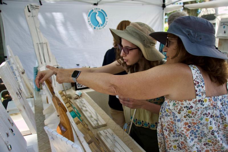 Rhiannon, left, and Pat Hawri consider which of Laura Haller’s pieces of jewelry they will be adding their collection at Blue Heron Heirlooms.