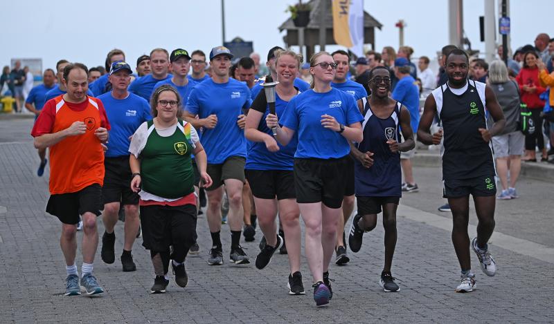 Rehoboth Beach seasonal police Officer Marie Fuller leads the Torch Run away from the Rehoboth Bandstand on a one-mile trek to Grove Park. She’s joined by Special Olympics Delaware athletes (l-r) Chris Truono of the Wilmington Wizards, Abby Galiardo of the Newark Dragons, Alyssa Unruh of the MOT Tigers, Chaz Moore of the Kent Wildcats and Deshawn Scye of the Sussex Riptide. NICK ROTH PHOTOS