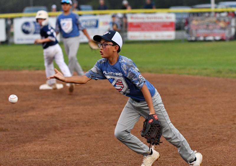 Lewes player Charlie Imperial tosses to first.