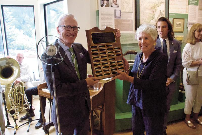 Peter Keeble, chair of the Lewes Historical Society Board of Trustees, presents former Chair Elizabeth Owen with a plaque honoring her accomplishments.