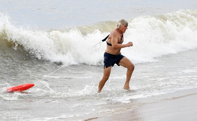 Chris Perreca leaves the surf in the buoy charges event, one of 10 physically challenging tests. DAN COOK PHOTO