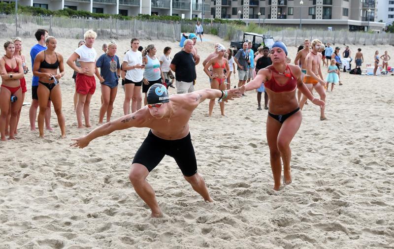 North Shores Beach Patrol’s Chase Norton, right, touches Josh Reinhold to start the third leg of the run-swim-run relay.