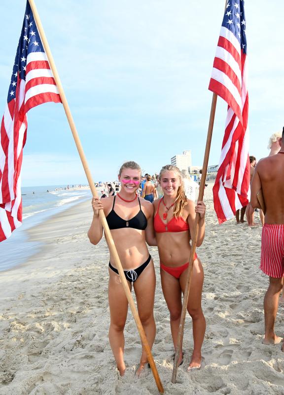 Rehoboth Beach Patrol’s Eliza Lust, left, and Brooke Balducci assist in scoring and holding finish line flags.