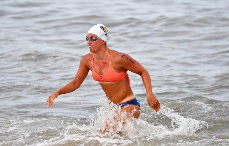 Suzannah Mills of the Delaware Seashore State Parks squad leaves the surf during the half-mile swim.
