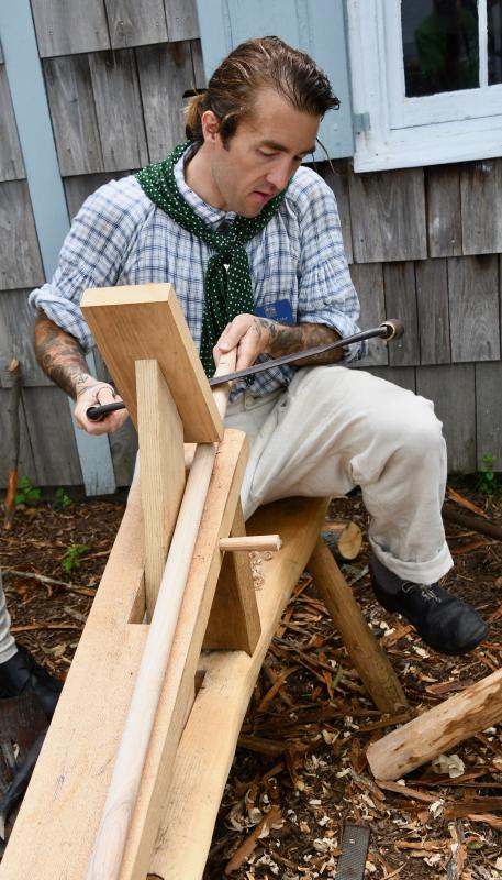 Lewes Historical Society Executive Director Andrew Lyter uses a drawknife to shave down the end of a handmade boat hook.