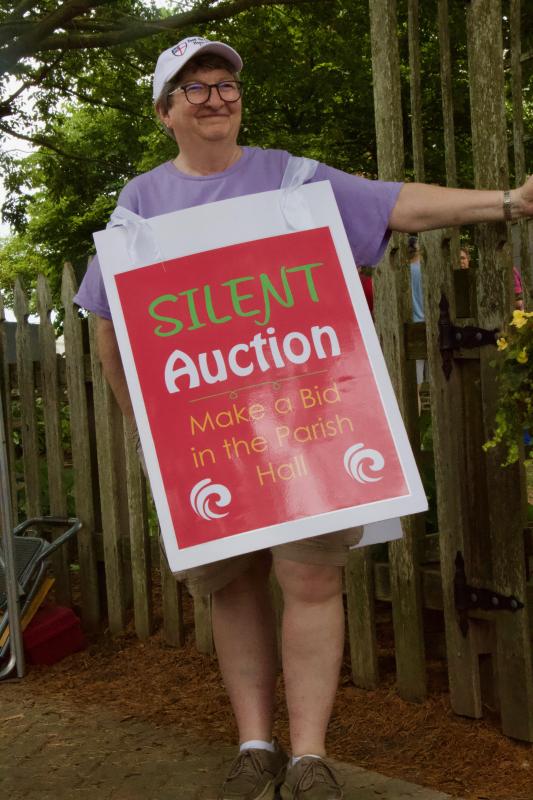 Lewes resident and St. Peter’s Episcopal Church member Joan Miller-Marcin directs guests to the silent auction inside the church.