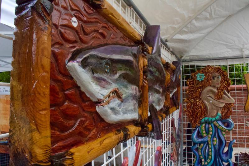 This mermaid couldn’t keep her eyes off of the great white shark patrolling the handmade wood carvings offered up by Bob Bohannon.