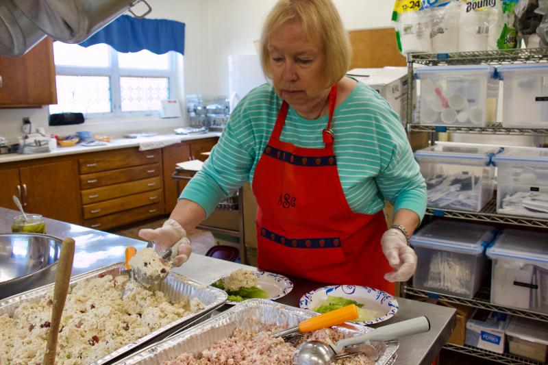 Sue Sprague of Rehoboth Beach dips into the chicken salad that had grapes and celery for a nice summer crunch.