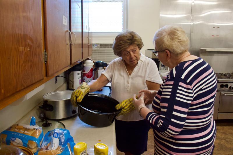 Lewes resident Pam Monty and Milton resident Cathy Ferree begin to breakdown a crock pot that was once full of chili for the hot dogs.