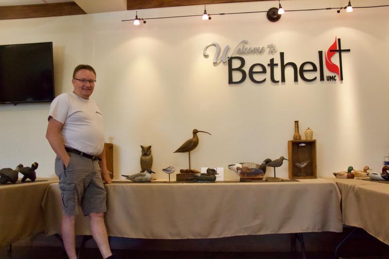 William S. Belote stands by “The Great Marsh” waterfowl carvings. Belote spoke fondly about his love for the natural environment.