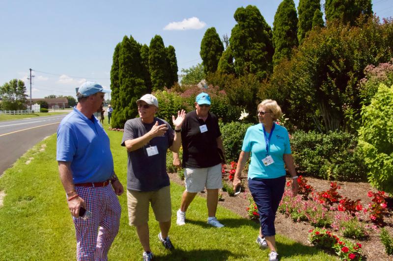 Bud Vai talks about various techniques utilized by Lewes in Bloom for the Gateway Garden during an onsite visit. Shown are (l-r) Ed Hooker III, Vai, Dave Beck and Sue Sandmeyer. AARON MUSHRUSH PHOTO