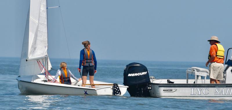 Club 420 sailors Emma and Julia Gummy receive some last-minute instructions from LYC Sailing Director Angus Robertson before the start of a race.