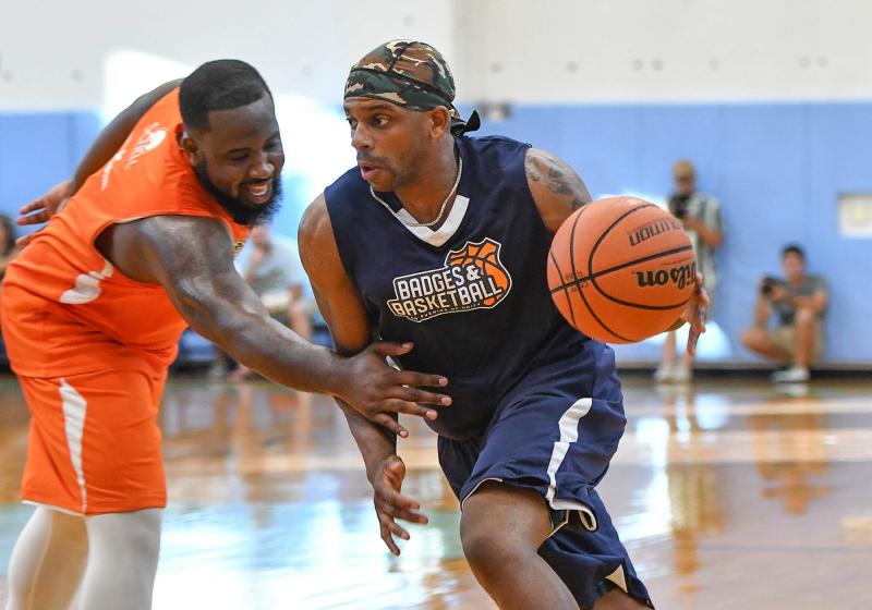 Jimmie Allen drives left on Juwan Mullen during the Badges and Basketball game at Cape Henlopen High School.