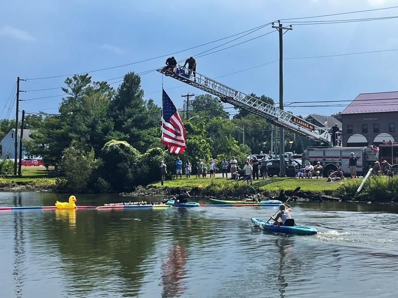 Rep. Steve Smyk, R-Milton, WRDE anchor Matt Pencek and Po’ Boys co-owner Melissa Clampitt race to collect ducks on the Broadkill River.