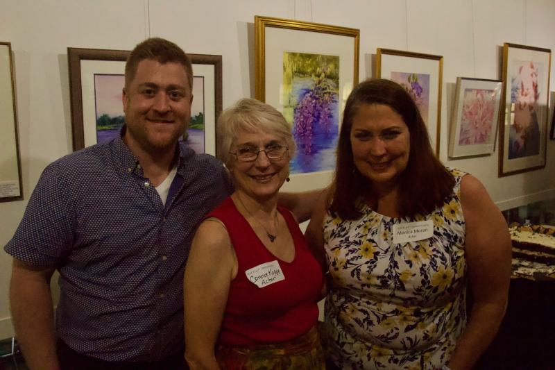 Patrick Seyfried, left, poses with actors Connie Koppe and Monica Moran as festivities came to a close.