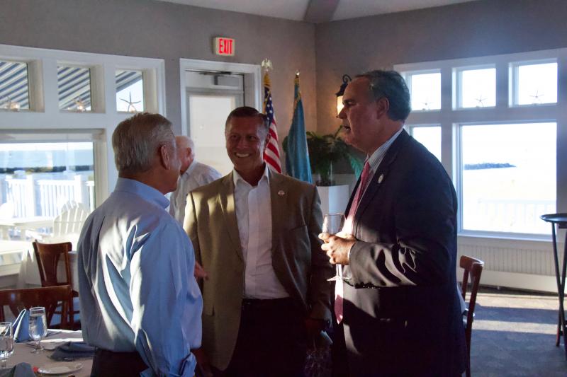 President of the Delaware Bay and River Cooperative Richard Gaudiosi talks to Rep. Steve Smyk, R-Milton, and Sen. Ernie Lopez, R-Lewes, about recent funding the two lawmakers helped DBRC secure. Gaudiosi says it will go to repair a ship that helps with cleaning oil spills in the Delaware Bay.