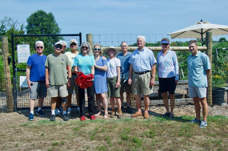The event celebrated the success of the garden, a first of its kind for the area, and the fence, which protects the unique project from unwanted critters. Community garden members worked with local leaders to make both visions become a reality. Shown are (l-r) Councilman Tim Ritzert, Lewes Community Garden co-founder Michael Whitehouse, Parks and Rec Commissioner Judi Jeffers, LCG member Lou Papp, LCG co-founder Cathy Harris, Judith Edwards, LCG member Perrin Smith, LCG member Patrick Gaffney, former Mayor Ted Becker, LCG member Barbee Kiker and Mayor Andrew Williams.