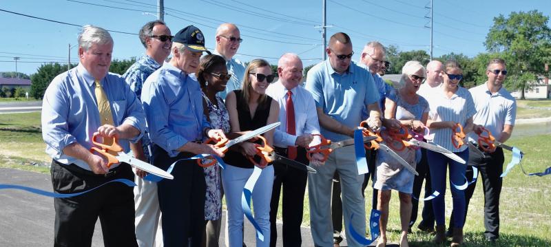 Taking part in the Aug. 9 ribbon cutting are (l-r) Sussex County Councilman John Rieley; Sen. Ernie Lopez, R-Lewes; U.S. Sen. Tom Carper, D-Delaware; DelDOT Deputy Secretary Shanté Hastings; Sussex County Council President Mike Vincent; DelDOT Secretary Nicole Majeski; Sussex County Councilman Doug Hudson; Sen. Brian Pettyjohn, R-Georgetown; Federal Highway Administration-Delaware Division Administrator Doug Atkin; Sussex Academy Executive Director Eric Anderson; Rep. Ruth Briggs King, R-Georgetown; Sussex County Administrator Todd Lawson; DelDOT project engineer Sarah Powell; and DelDOT project engineer Bryan Behrens. RON MACARTHUR PHOTOS