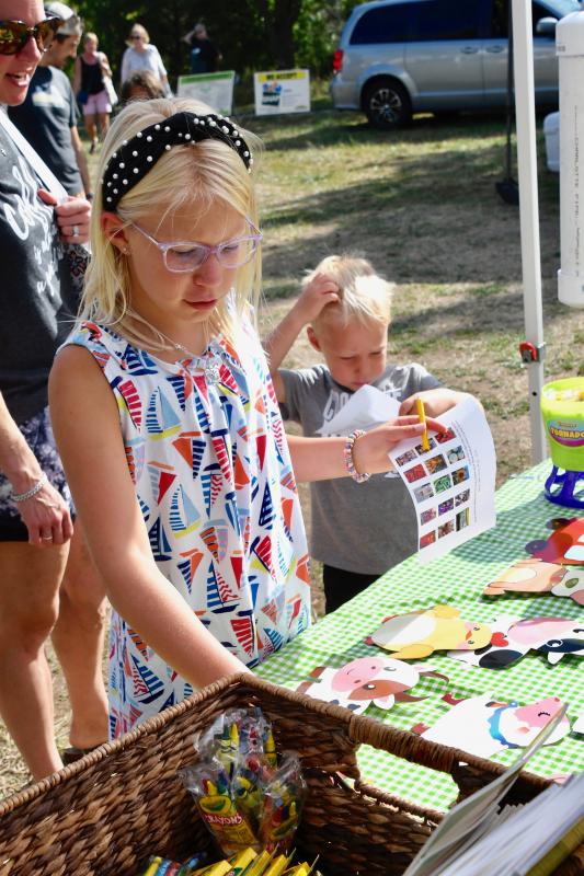 Victoria and Grant Pyle get the lowdown at the information booth on children’s activities at the Aug. 20 Historic Lewes Farmers Market.