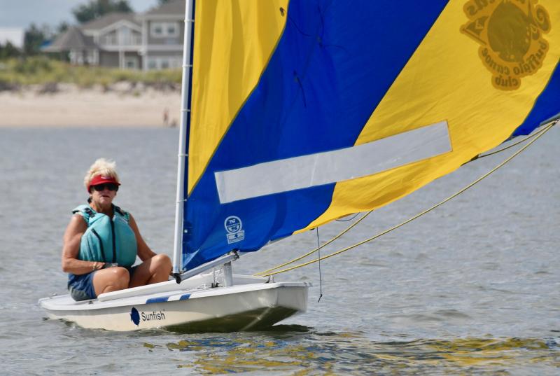 LYC sailor and regatta organizer Connie Miller flies her friend Betsy Schmidt’s Sunfish sail in honor of the veteran sailor who passed away in March.