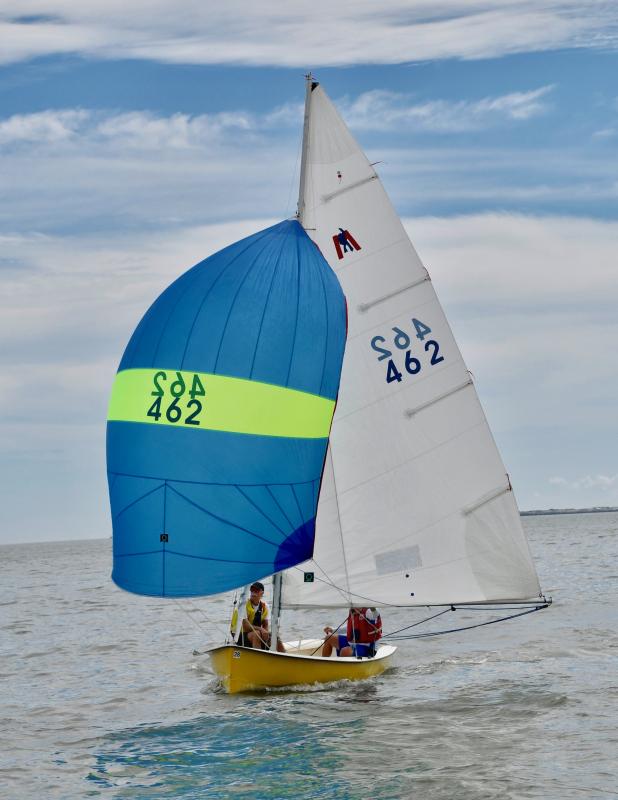 The Mobjack champion team of Mark Arnold and Matt Frank use their spinnaker to capture as much wind as possible.