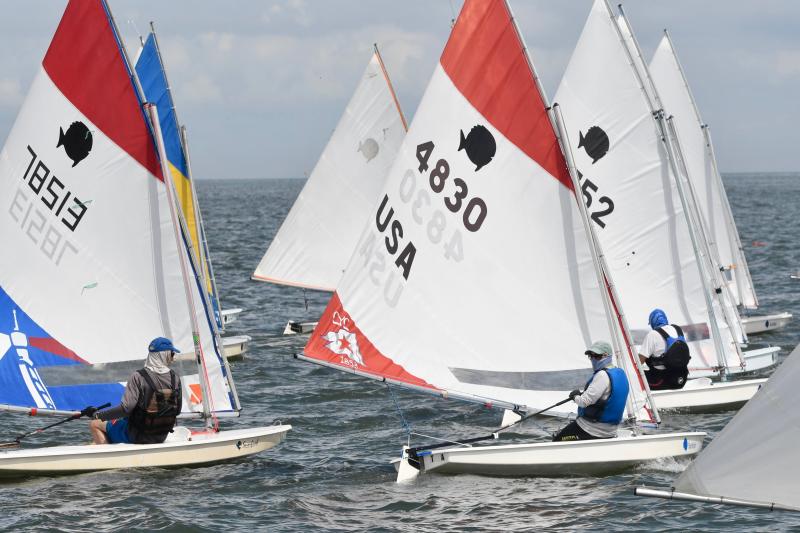 The start of the fifth Sunfish race was a recall because too many sailors crossed the starting line before the official start.