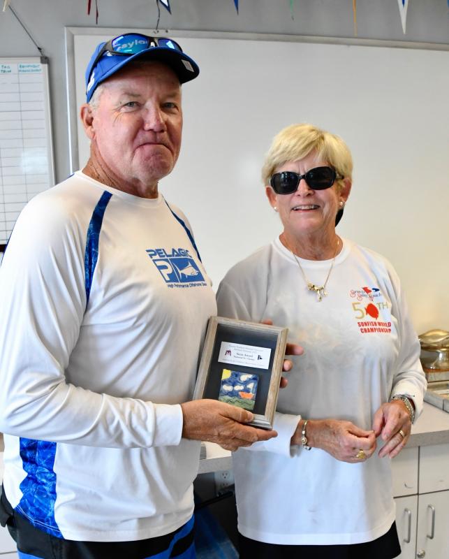 Mobjack sailor Mark Arnold is presented with the National Senior Champion Stein Award by Connie Miller, regatta organizer.