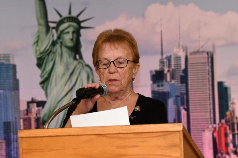 June Jones, Post 28 Auxiliary president, reads the description of the 10 elements of the Freedom Flag.