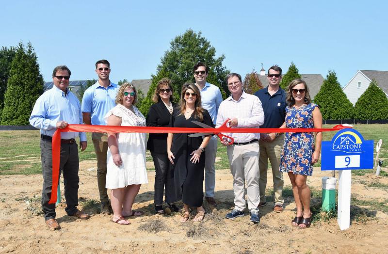 Shown at the ribbon cutting for Catching Cove are (l-r) Bob Reed of RE/MAX Realty Group, Brent Reed of Capstone Homes, Susy Lamborn of Guild Mortgage, Debbie Reed of the Debbie Reed Team, Ashlee Reed Hidell of the Debbie Reed Team, Tim Hidell of Guild Mortgage, BJ Mitchell of Capstone Homes, Joe Reed and Jessica Mattioni of Capstone Homes. DAN COOK PHOTOS