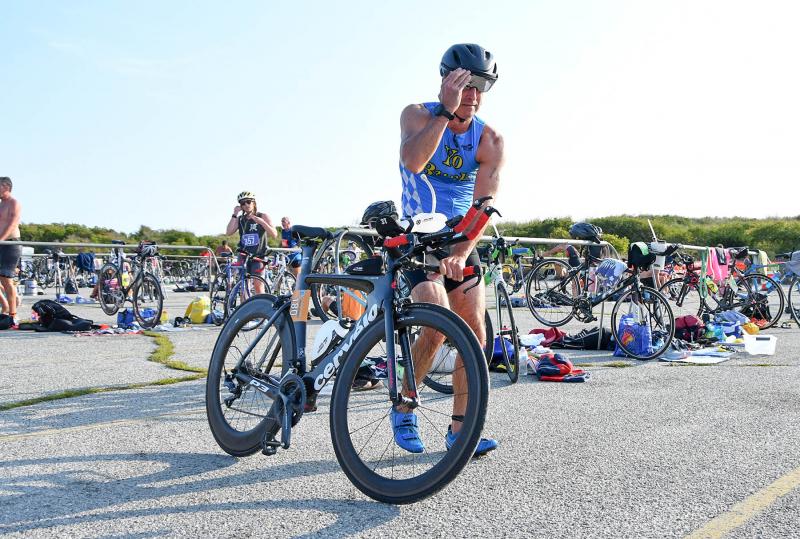 Vincent Browning makes last-minute adjustments in the transition area. He finished fourth in the 55-59 age group.