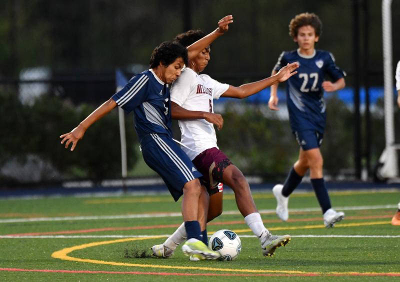 Sussex Academy’s Joseph Herrera Gomez takes a shot despite the defense by Milford’s Alvaro Carrillo.