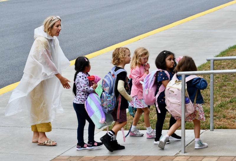 Lewes Elementary School paraeducator Chantal Smith guides young students up the ramp on their first day of school. RON MACARTHUR PHOTO