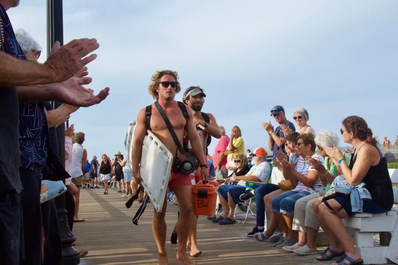 Bethany Beach Beach Patrol lifeguards receive thunderous applause as they walk off the beach for their final shifts of summer.