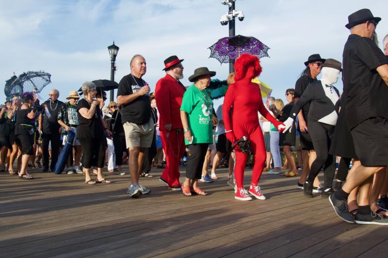 The procession of mourners followed the casket and band along the Bethany Beach boardwalk. The bayou taste in fashion is because jazz funerals stem from a tradition in New Orleans.