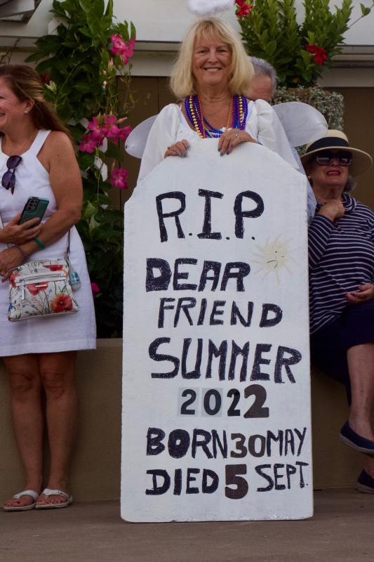 Jazz Funeral Co-Chair Angel Carolyn Bacon carries the tombstone of the Summer ‘22, which came into this world, unofficially, May 30 and crossed the river Styx, unofficially, Sept. 5.
