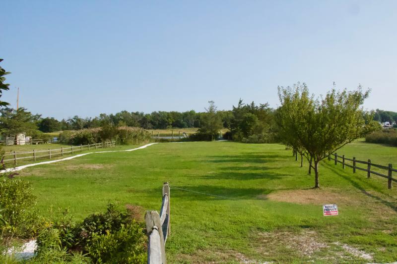 The lots are designated open space, but are private property. The owners are permitted to construct, install and plant anything they choose as long as it complies with code and viewshed regulations.