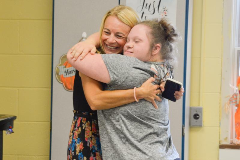 Assistant Superintendent Jenny Nauman gets a bear hug from Life Skills student Kelsea Showard. SUBMITTED PHOTO