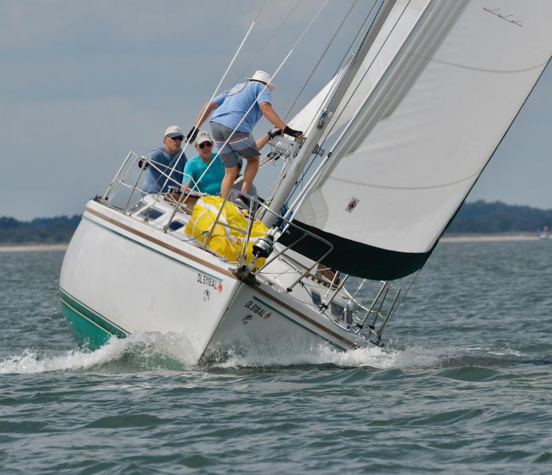 The crew of Mystery works to get into position to balance their boat as it uses a strong breeze to pick up speed. Mystery finished in second place in the keel boat division of the LYC breakwater race.