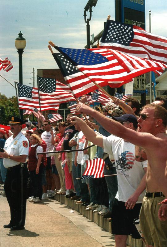 People line the street waving American flags as Westboro Baptist Church members spread their message of hate during a May 2006 protest in Seaford. RON MACARTHUR PHOTO
