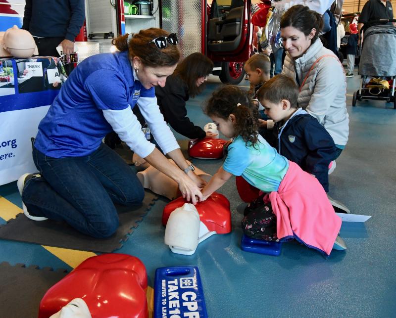 Corey Kennedy, Beebe Training Center coordinator, shows Adeline and Charlie Cox of Lewes the proper CPR technique.